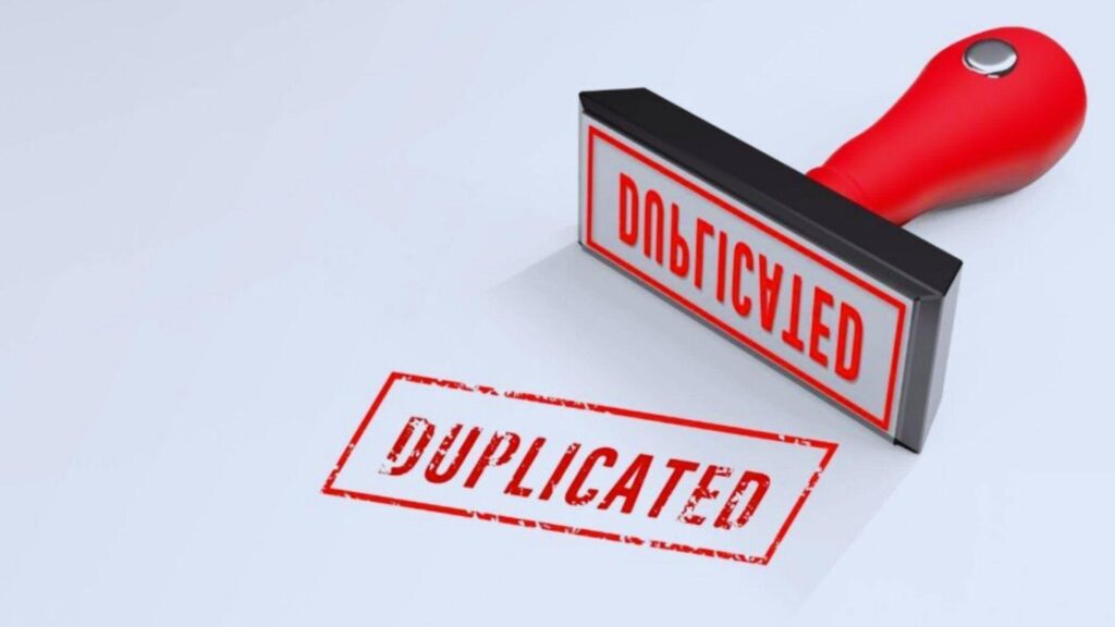 Red rubber stamp marking duplicated content warning for SEO duplicate content penalty avoidance