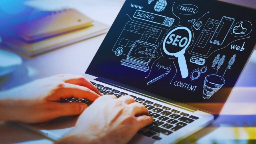 Person typing on laptop displaying SEO diagram with keywords, content and referring domains strategy